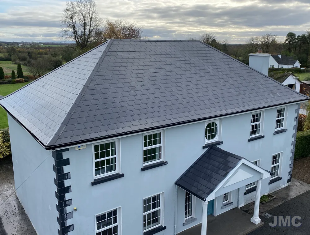 A hipped slate roof after moss removal, seen from above